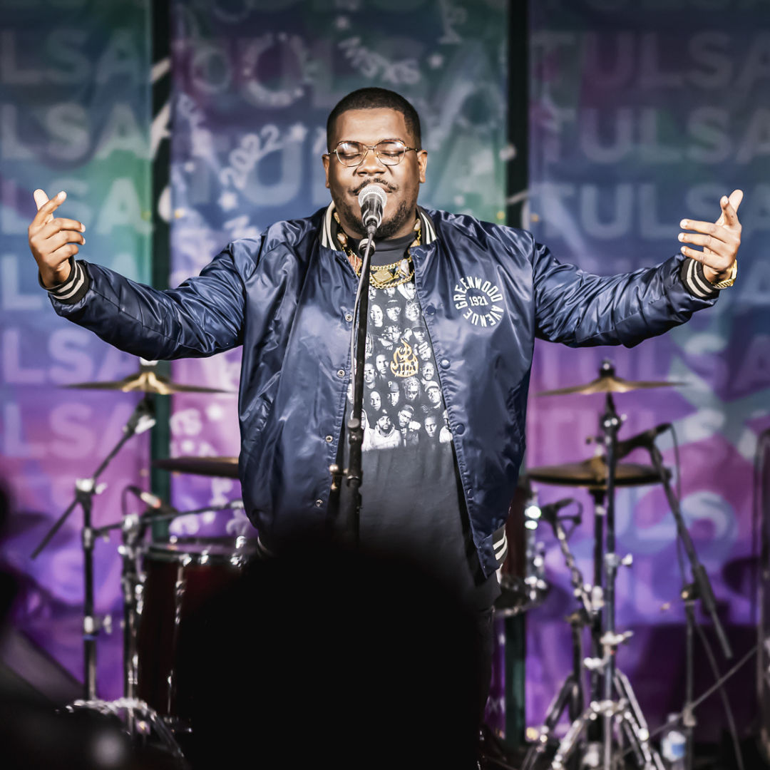 Steph Simon, Founder of Dreamland Music Festival rapping at an event