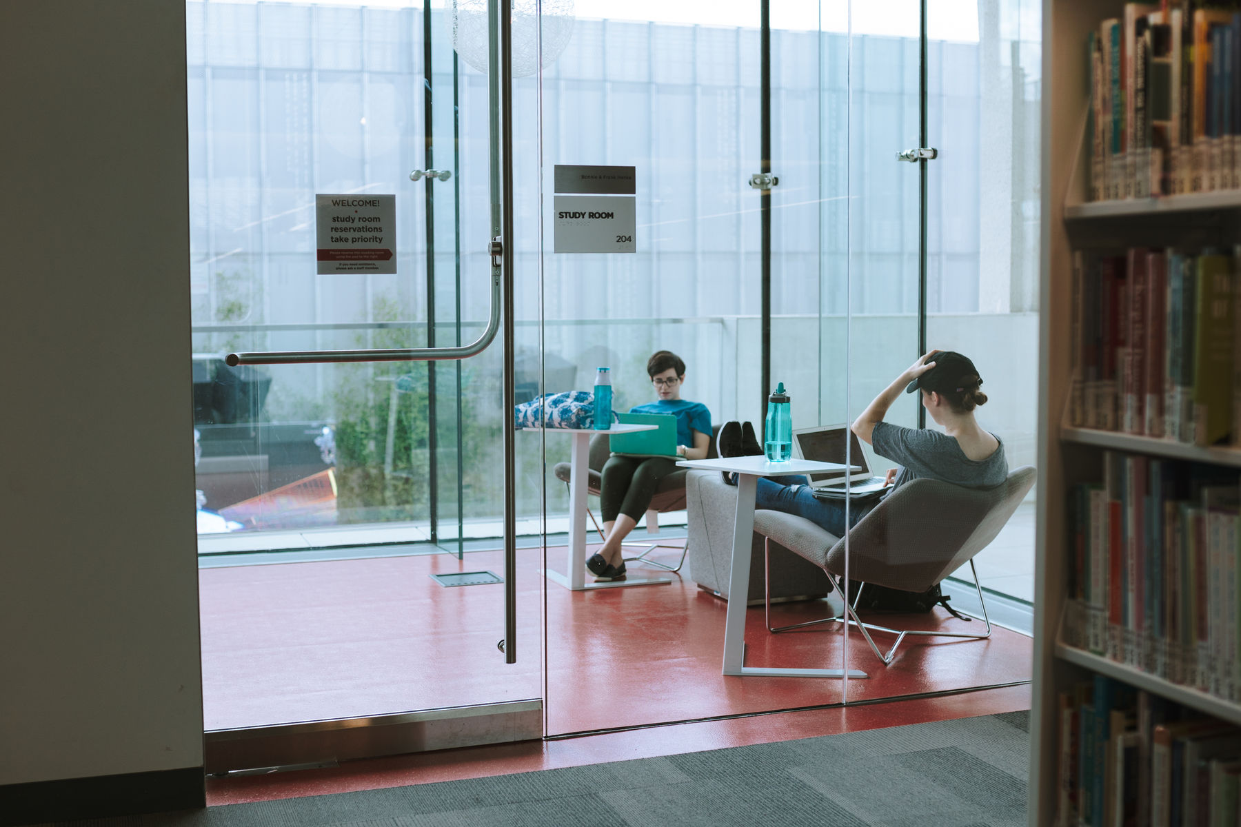 Students doing homework in a private study room in Tulsa Library