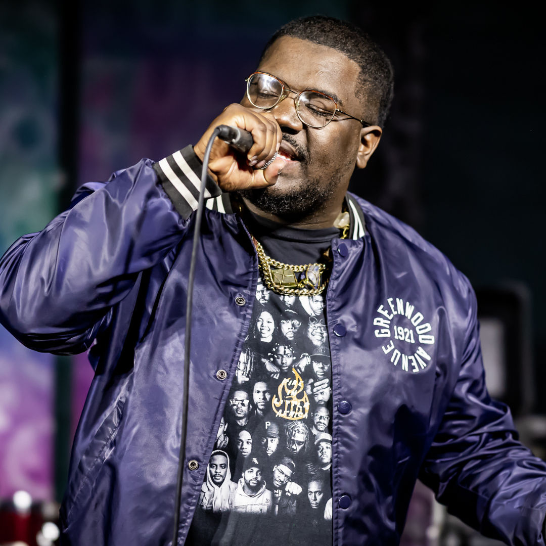 Steph Simon, Founder of Dreamland Music Festival rapping at an event